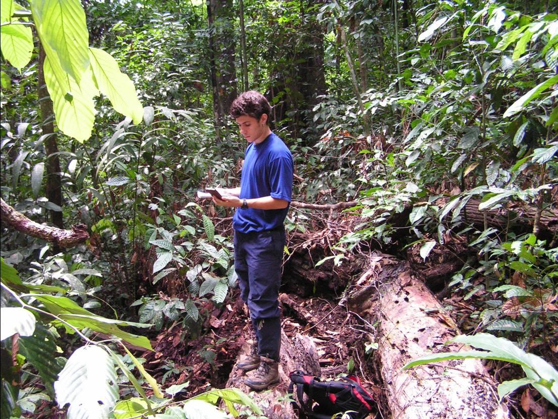 A young researcher measures the light environment after a liana cutting treatment in Sabah, Malaysian Borneo, in the early 2000s
